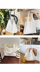 Detailed close-up of white polka dot canvas tote bag with decorative black and white ribbon