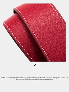 Detail of red pebbled leather bag strap with 4.1cm width and white contrast stitching