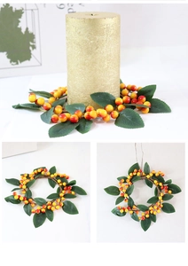 Detail of faux berry candle ring with orange and red gradient berries and green leaves