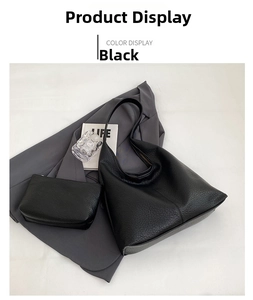 Detail of black pebbled leather tote bag with matching pouch and premium metal hardware