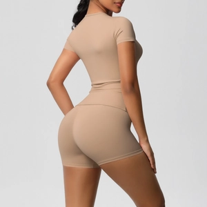 Detailed back view of high-elasticity yoga set with tight t-shirt and shorts in nude