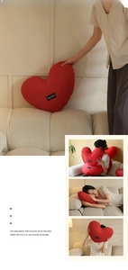 Detail of red heart pillow with Happy Home label on soft fabric for sofa decor