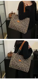 Detail of leopard print tote bag with brown leather handles and metal chain accents
