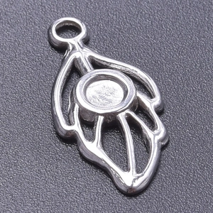 Macro shot of silver stainless steel leaf pendant base with a circular bezel setting