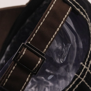 Detail of adjustable metal buckle and canvas strap on embroidered baseball cap