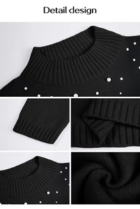 Détails de la robe pull noire montrant le col montant côtelé et les perles blanches
