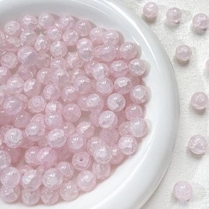 Macro view of 10mm pink ice-crackled glass beads for DIY jewelry making and crafts