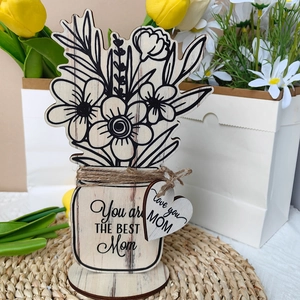 Close-up of Mother's Day wooden flower decor with engraved Best Mom message and twine detail