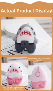 Detail of plush shark keychains in grey and pink with soft fabric and metal rings