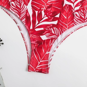Detailed macro view of tropical leaf print bikini bottom with double-stitched hem edges
