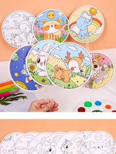 Close-up of children's DIY coloring fans featuring cartoon animal patterns and art supplies