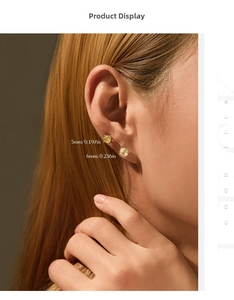 Model wearing yellow round-cut stud earrings in 5mm and 6mm sizes with gold plating