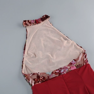 Detail of burgundy halter neck dress with intricate floral embroidery and sequins