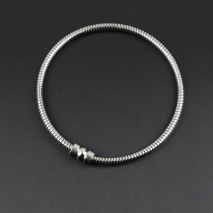 Detail of silver stainless steel snake chain bracelet with magnetic closure and smooth finish