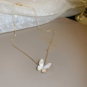 Elegant gold necklace featuring a white butterfly shell pendant with sparkling zircon detail