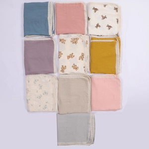 Variety of muslin baby swaddle blankets with lace trim in different colors and prints