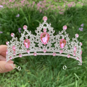 Close-up of bridal crown featuring pink teardrop gemstones and clear rhinestones