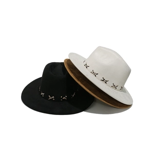 Detailed view of three wide-brim fedora hats in black, white, and brown with cross-stitch
