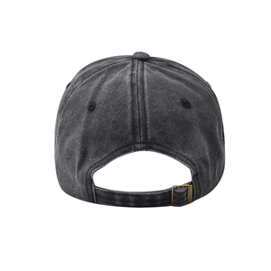 Detail of adjustable metal buckle and vintage washed denim texture on baseball cap