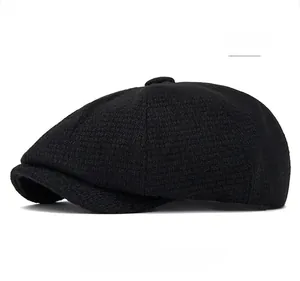 Side view of black newsboy cap showing textured knit fabric and top button detail