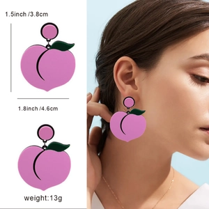 Pink peach acrylic earrings with green leaf detail and female model display