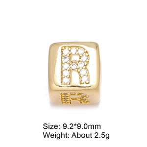 Close-up of gold plated 8mm letter R bead charm with micro-paved cubic zirconia