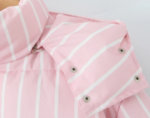 Detail view of pink and white striped hooded jacket with silver zipper and snap buttons