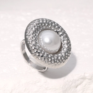 Detailed macro view of retro silver hammer textured ring with a large white pearl inlay