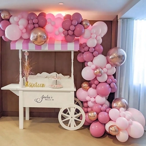 Pink and rose gold balloon arch kit with metallic accents for wedding party decoration