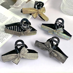 Set of five elegant bow-shaped hair claws with sparkling rhinestones in assorted colors