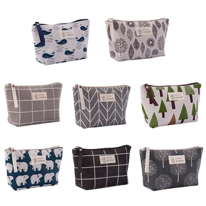 Variety of canvas makeup bags featuring nature patterns like whales and trees