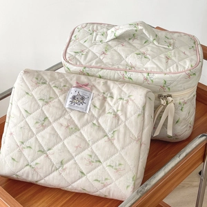 Quilted cosmetic bag set with elephant pattern and pink bow design details