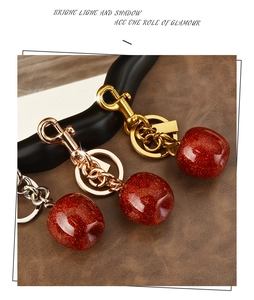 Three red glitter apple keychains with gold, silver and rose gold metal rings