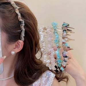 Detail view of acrylic hair clips with colorful irregular crushed stone decorations
