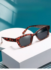 Detail of tortoise shell sunglasses with square frames and silver metal hardware