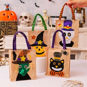 Halloween burlap treat bags featuring pumpkin, ghost, and black cat designs with handles