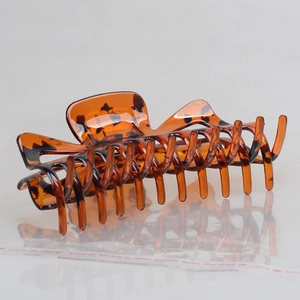 Macro detail of large tortoiseshell amber hair claw clip with strong interlocking teeth