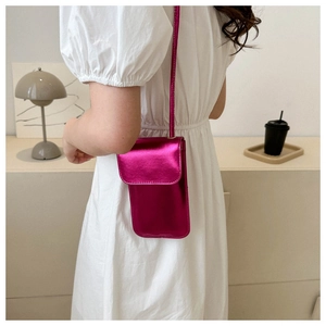 Chic magenta metallic small crossbody phone bag worn over a white puff sleeve dress