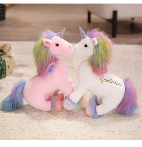 Detail of pink and white plush unicorns with rainbow manes and Goodness embroidery