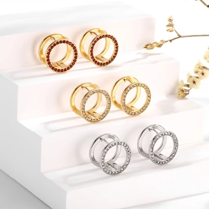Three geometric hollow earrings with cubic zirconia in gold and silver finish on steps
