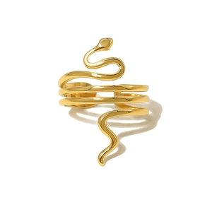 Macro detail of the gold-plated snake-shaped wrap ring with multi-layered spiral design