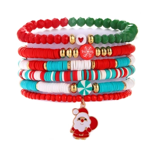 Detail of Christmas stackable bracelets with Santa charm, red and green beads