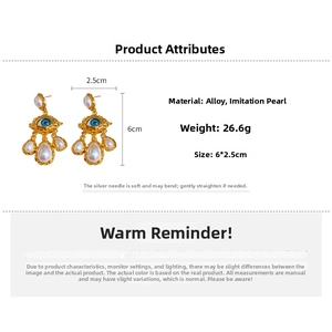 Detail view of retro eye earrings with faux pearls, measuring 6x2.5cm and weighing 26.6g