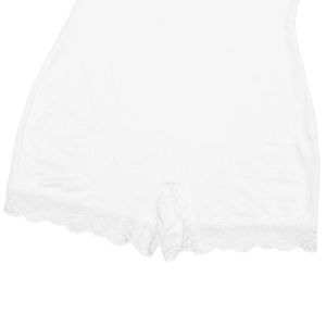 Macro shot of white shapewear bodysuit featuring delicate floral lace trim edges