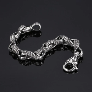 Macro view of retro hammer-textured stainless steel chain bracelet with large clasp