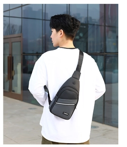 Detail of durable grey oxford fabric chest bag with front zipper and fashion label