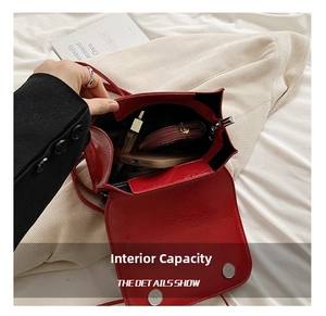 Top view of red patent leather crossbody bag showing internal storage capacity for phone