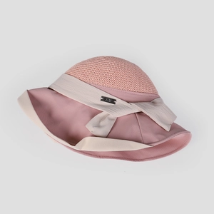 Close-up detail of an elegant women's pink breathable mesh sun hat with bow ribbon