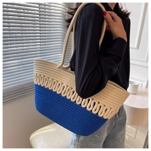 Detailed macro view of blue and beige handwoven cotton rope tote bag with sturdy handles