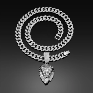 Detailed view of silver Cuban chain necklace with a rhinestone-encrusted lion head pendant